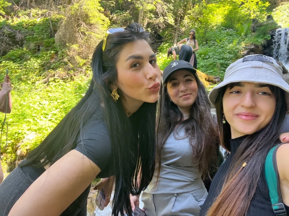 Effy and fellow travelers taking a group selfie in a forest