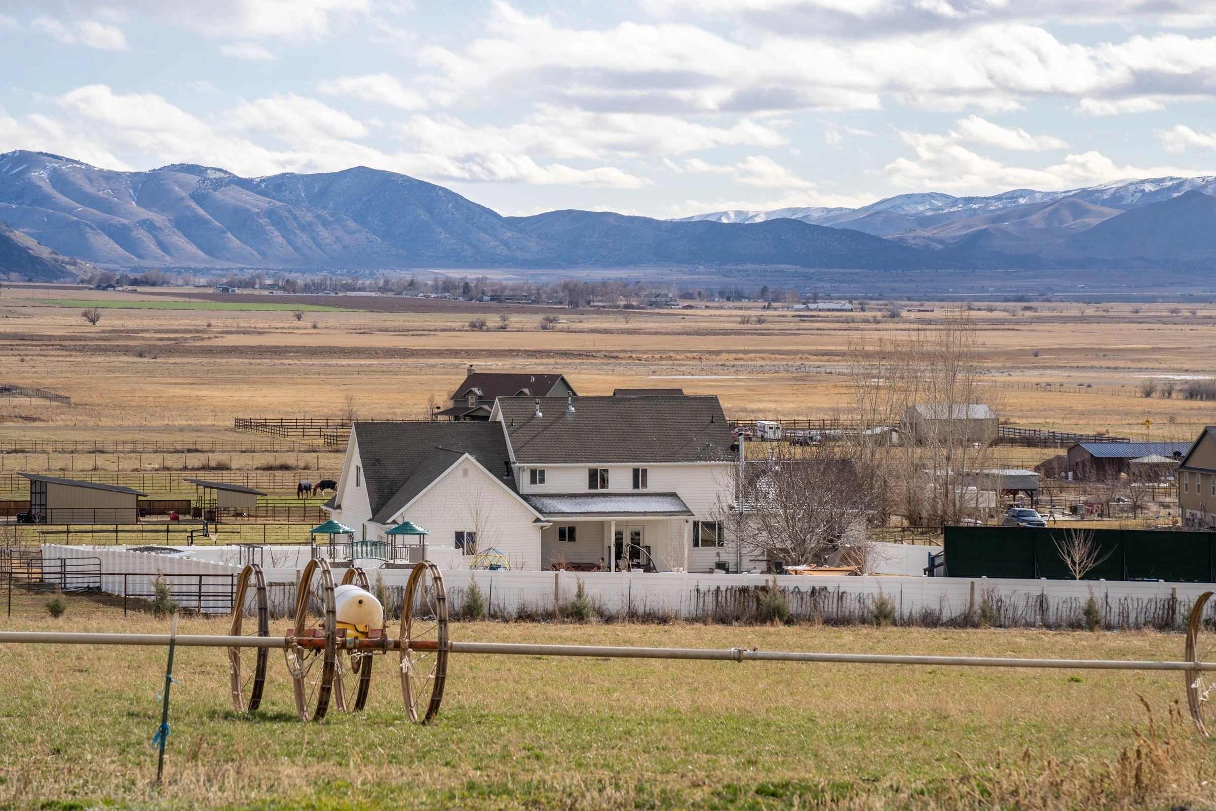 Farmhouse with wheel-line irrigation in a wide mountain valley
