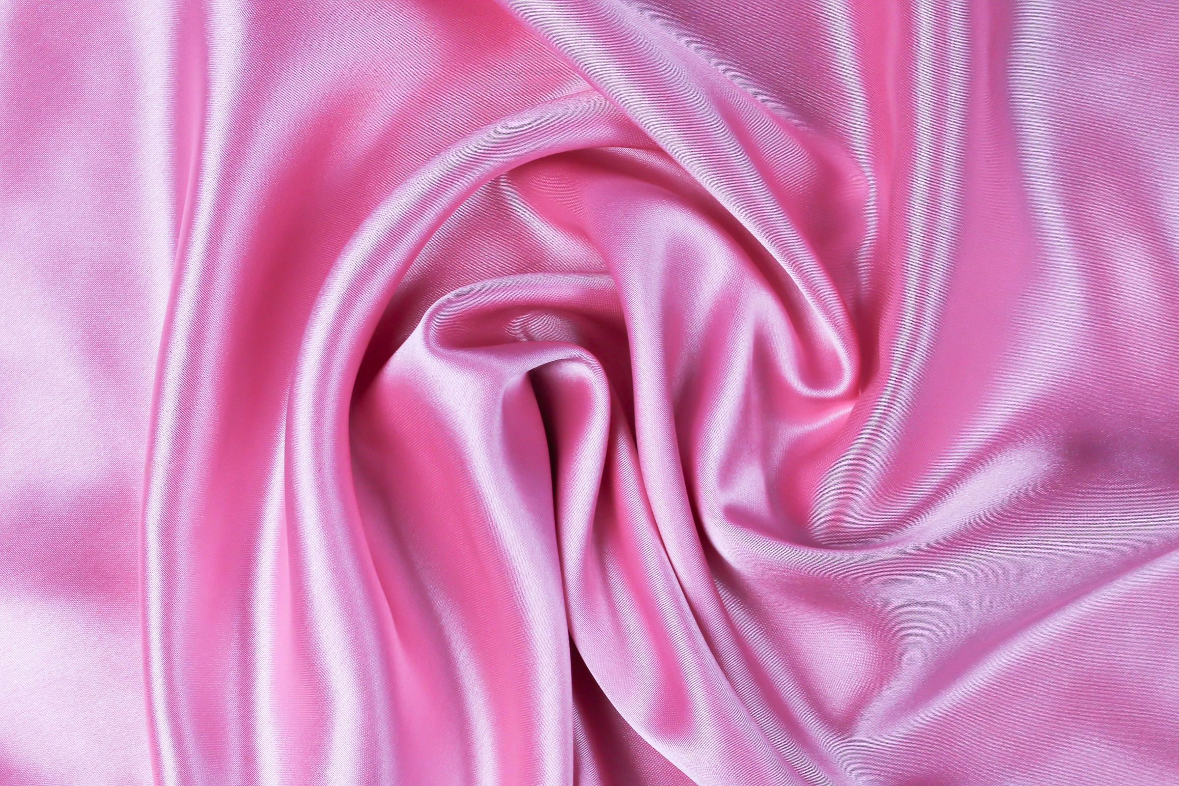 Swirling pink silk satin fabric