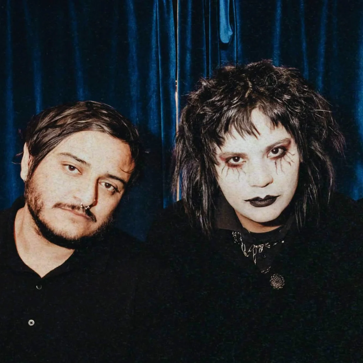 Kevin Moreno and Francisco Saenz of DECEITS in front of a blue curtain