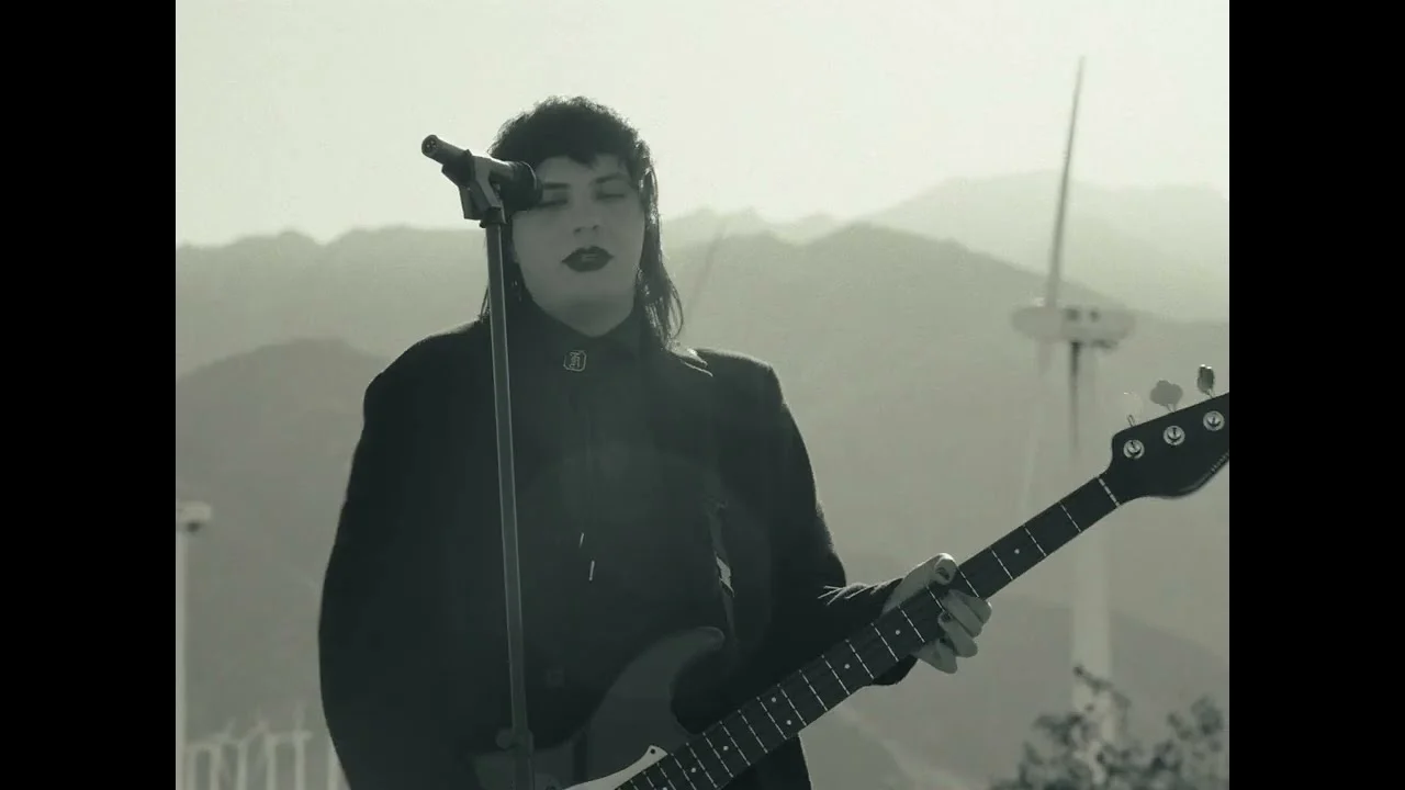 Monochrome performance still from Please, Wake Up music video