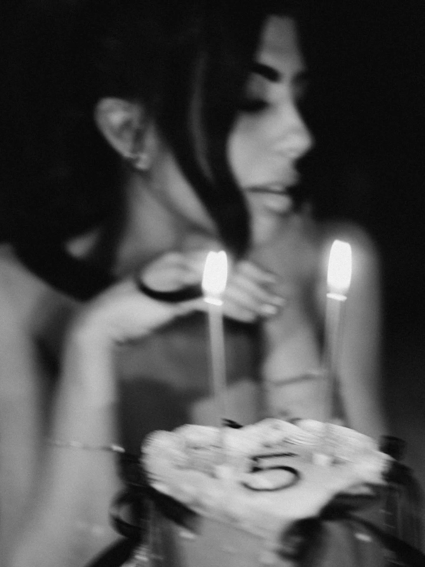Black-and-white motion study of a celebration with candles
