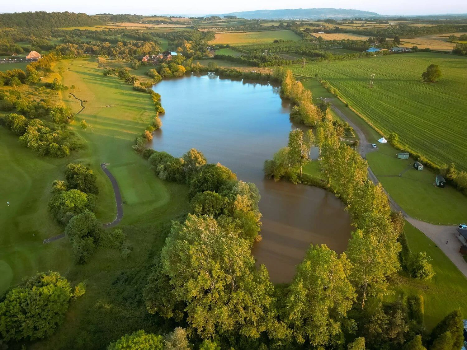 Aerial view of the Watersedge lake surrounded by Worcestershire fields