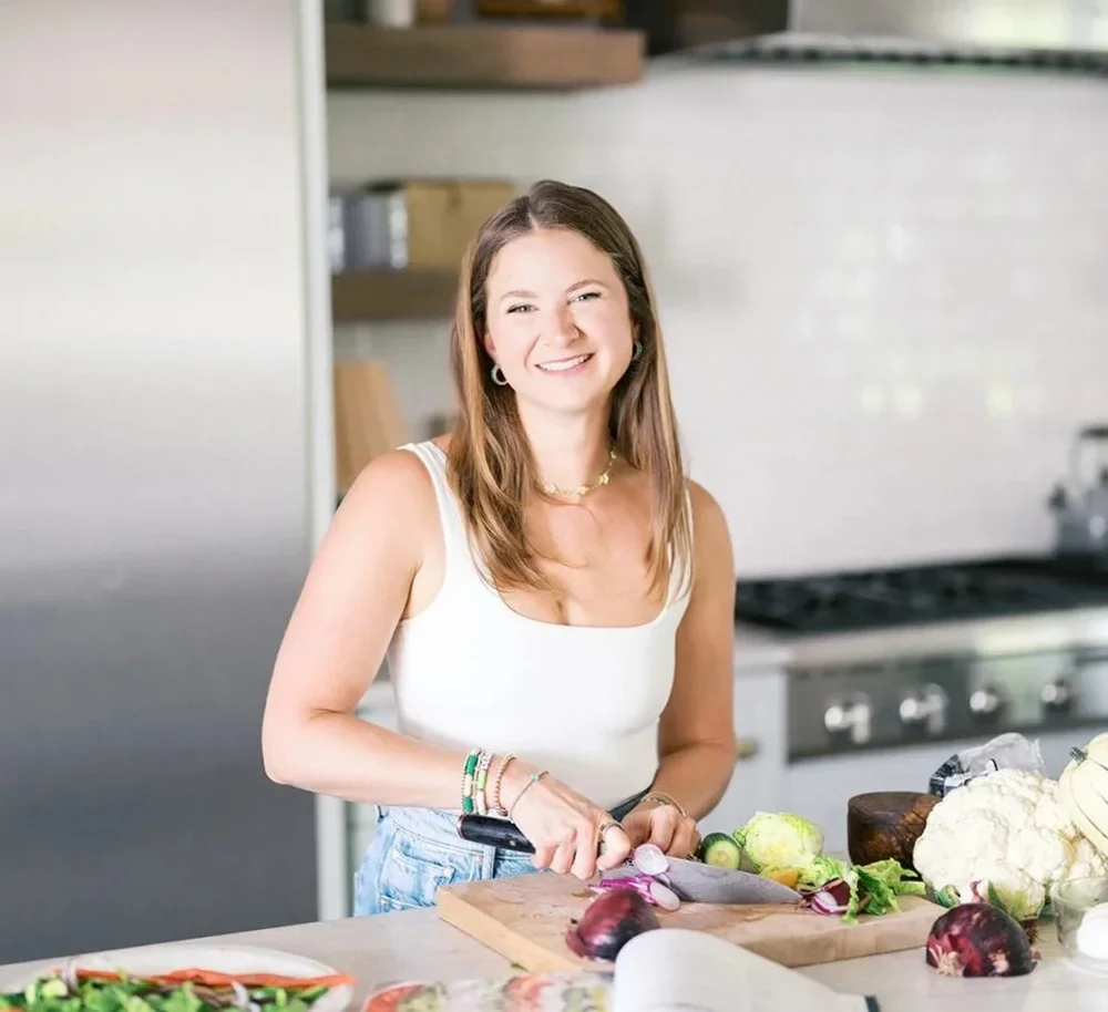 Kathryn Becker preparing vegetables in a bright kitchen