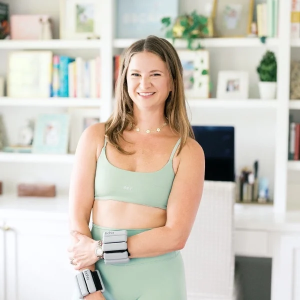 Kathryn Becker smiling in pale green activewear