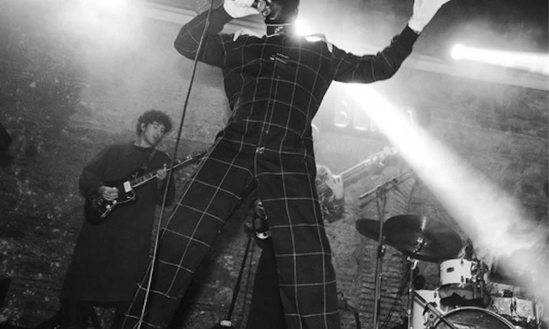 Black-and-white photograph of FEZ performing live