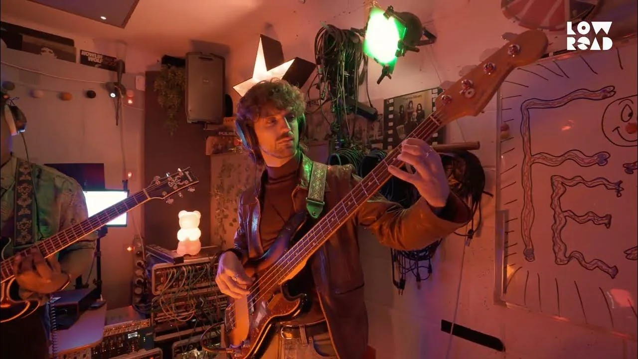 FEZ performing in a warm red live-room setting at Low Road Studios