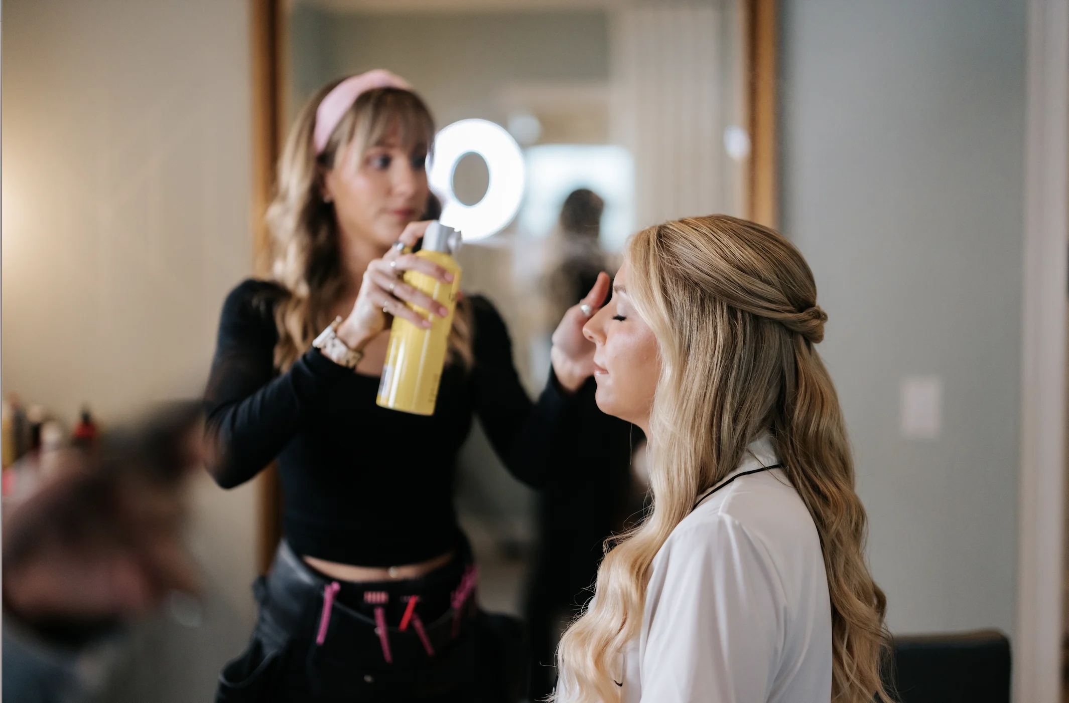 Becki hairspraying a bride