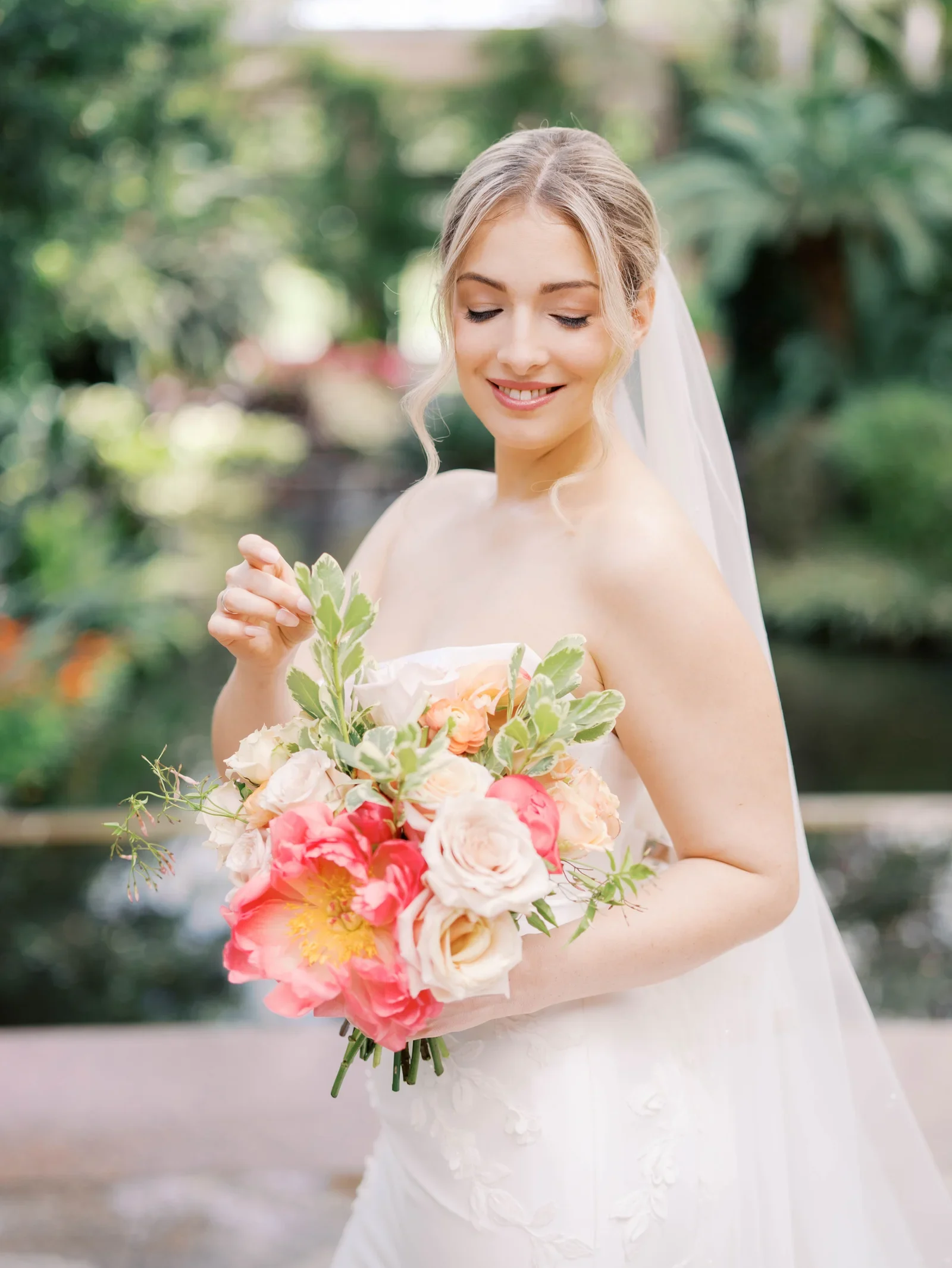 Bride holding a colorful bouquet beneath her veil