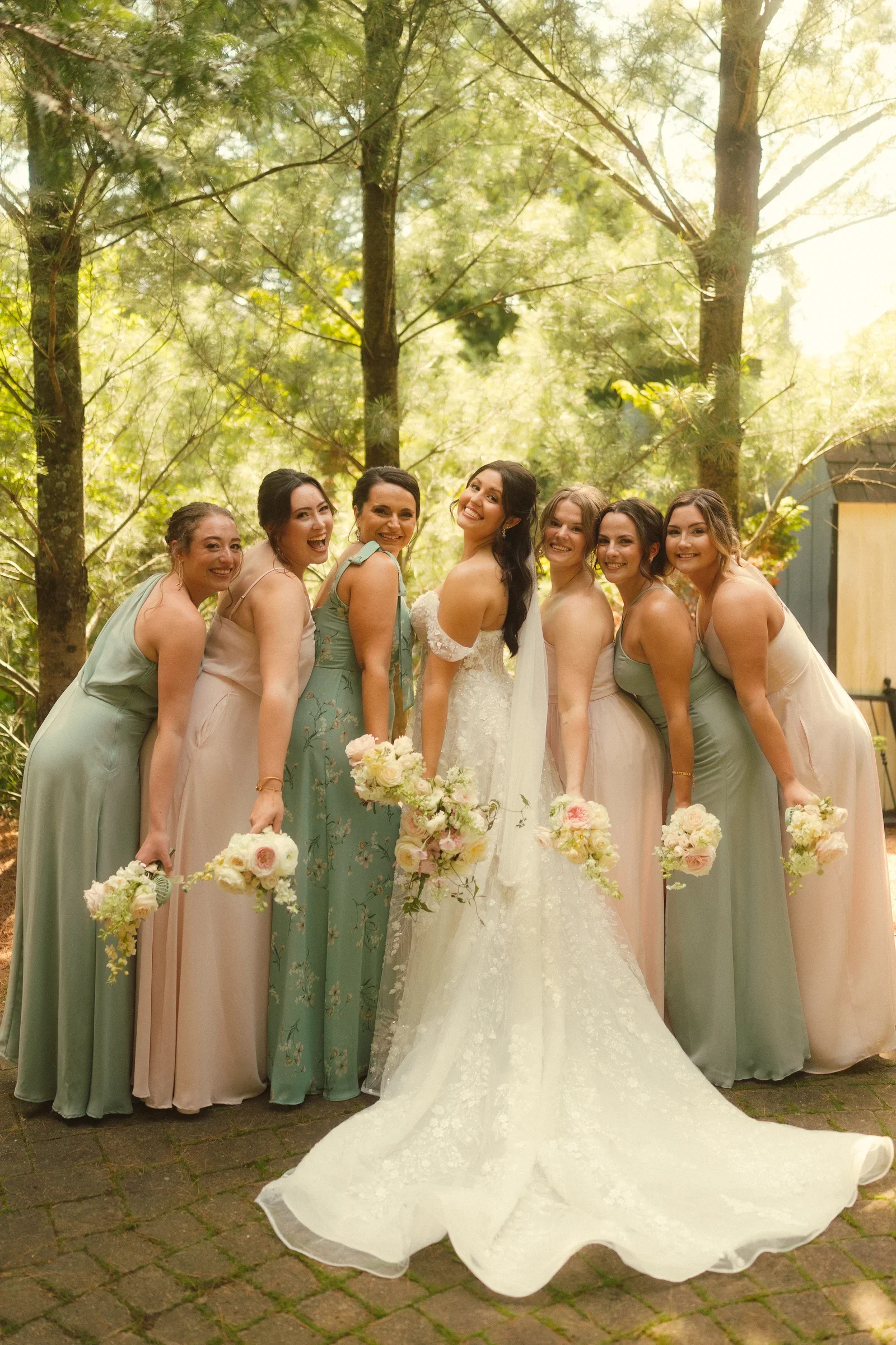 Bride and bridesmaids together in warm sunlight