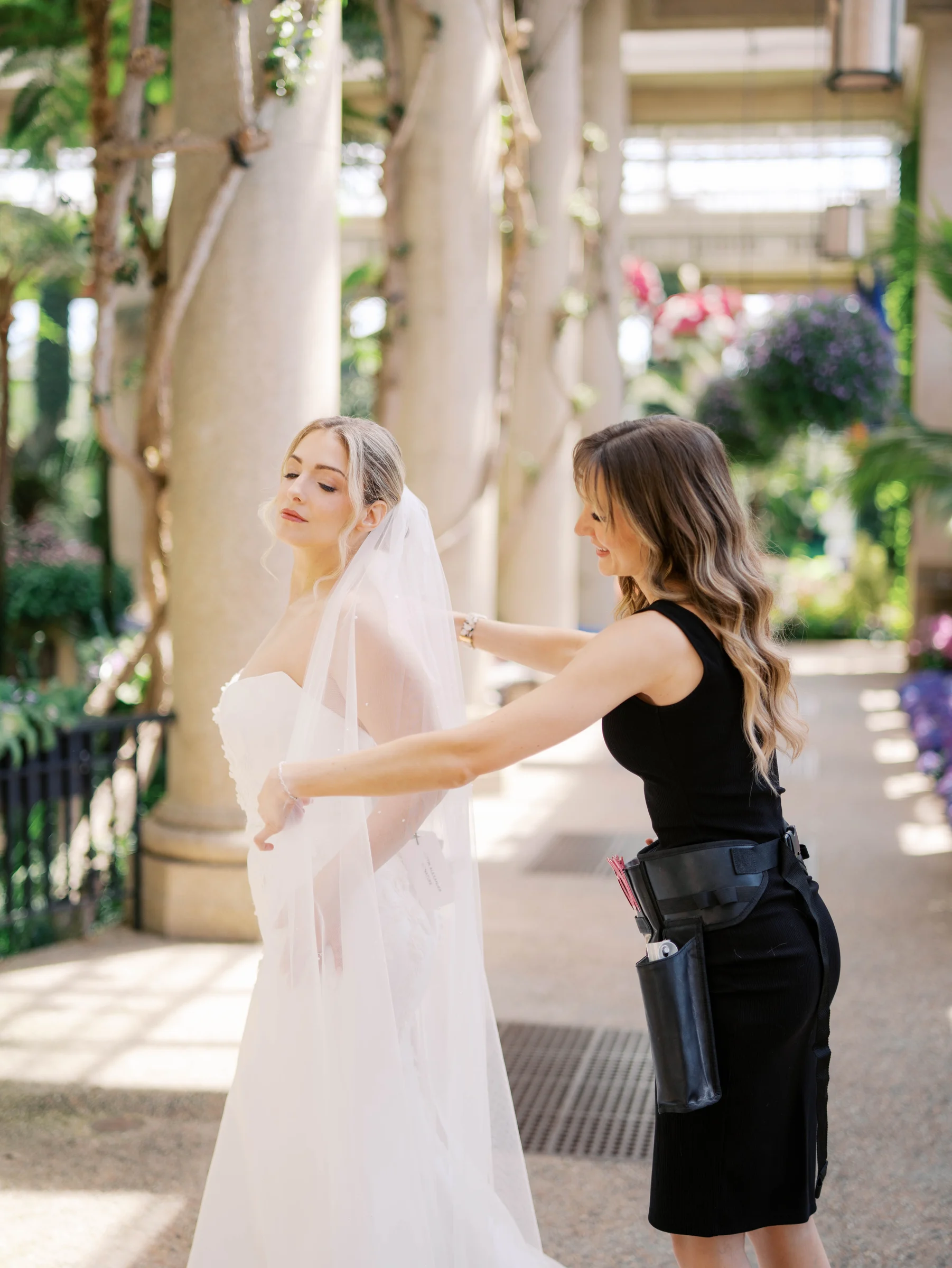 Becki helping a bride with her veil