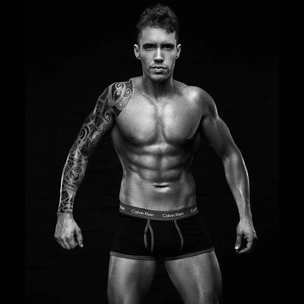 Ash Fox in a black-and-white fitness portrait