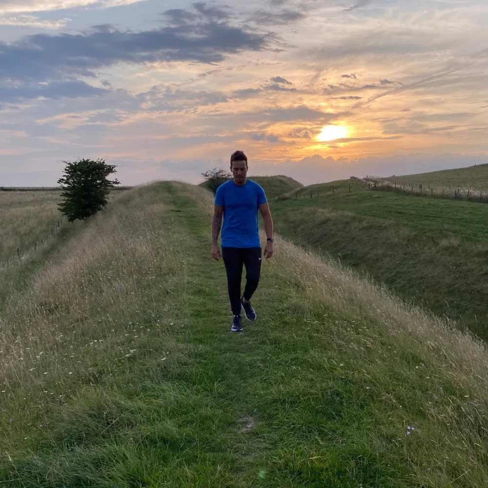 Ash Fox walking outdoors at sunset