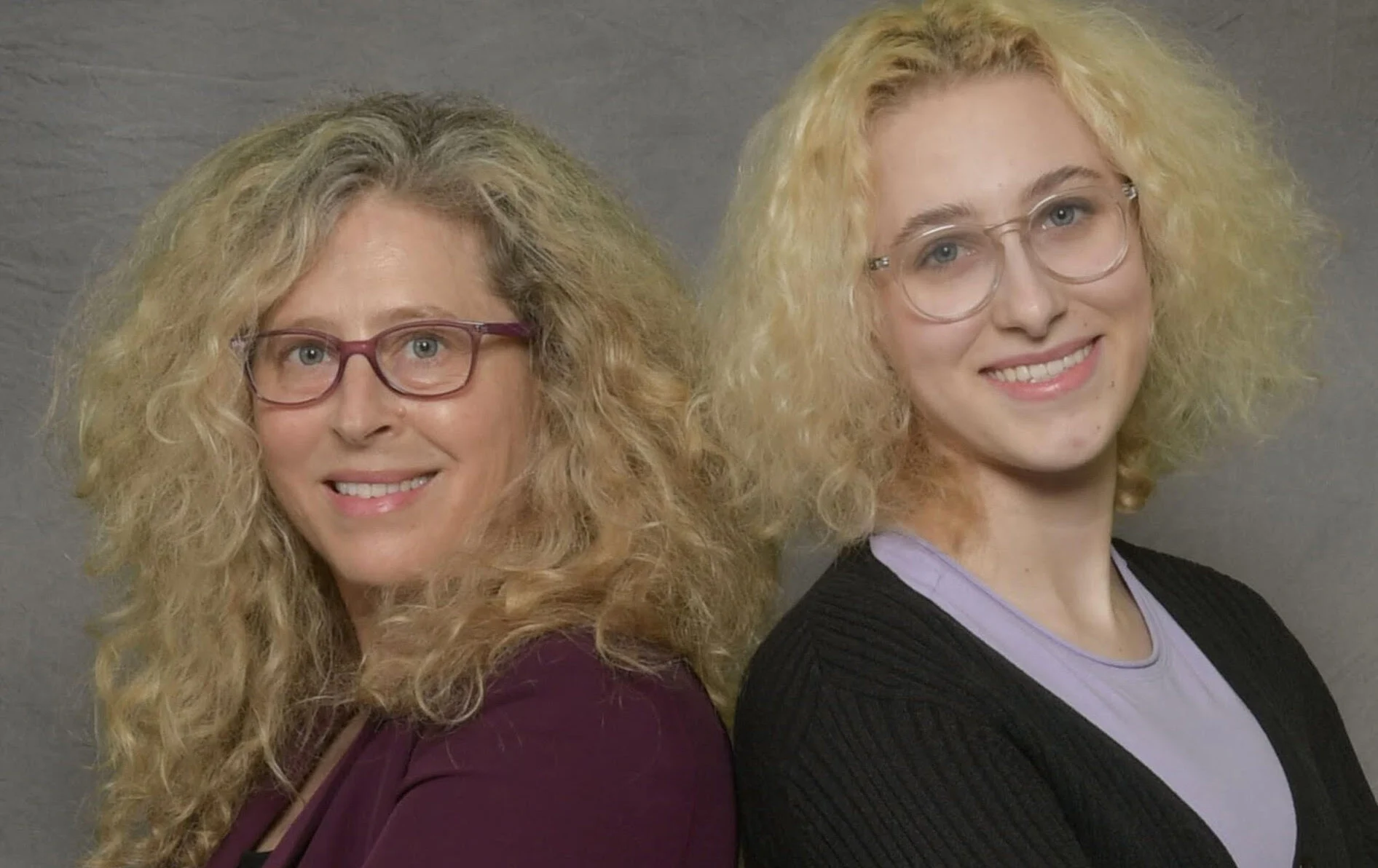 MEMF co-founders Corrina Clover Miller and Marta Eliza Miller standing back to back