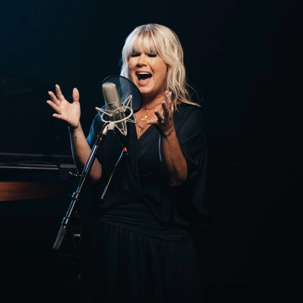 Natalie Grant singing at a studio microphone