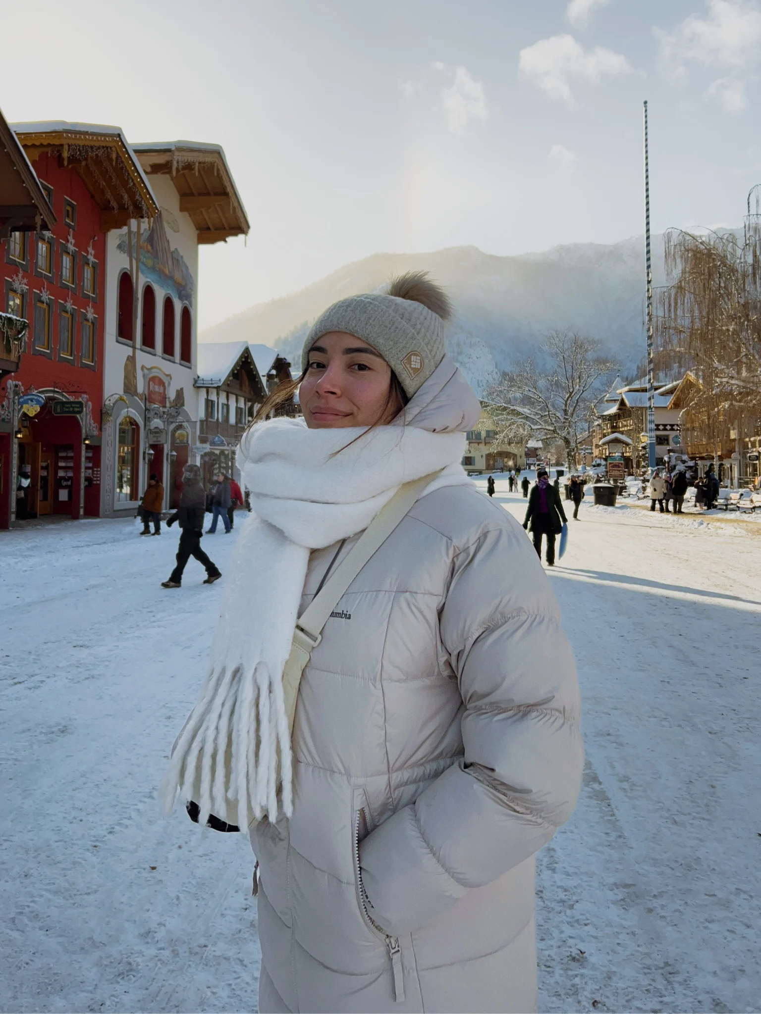 Arabella in a white puffer coat on a snowy street in Leavenworth, Washington