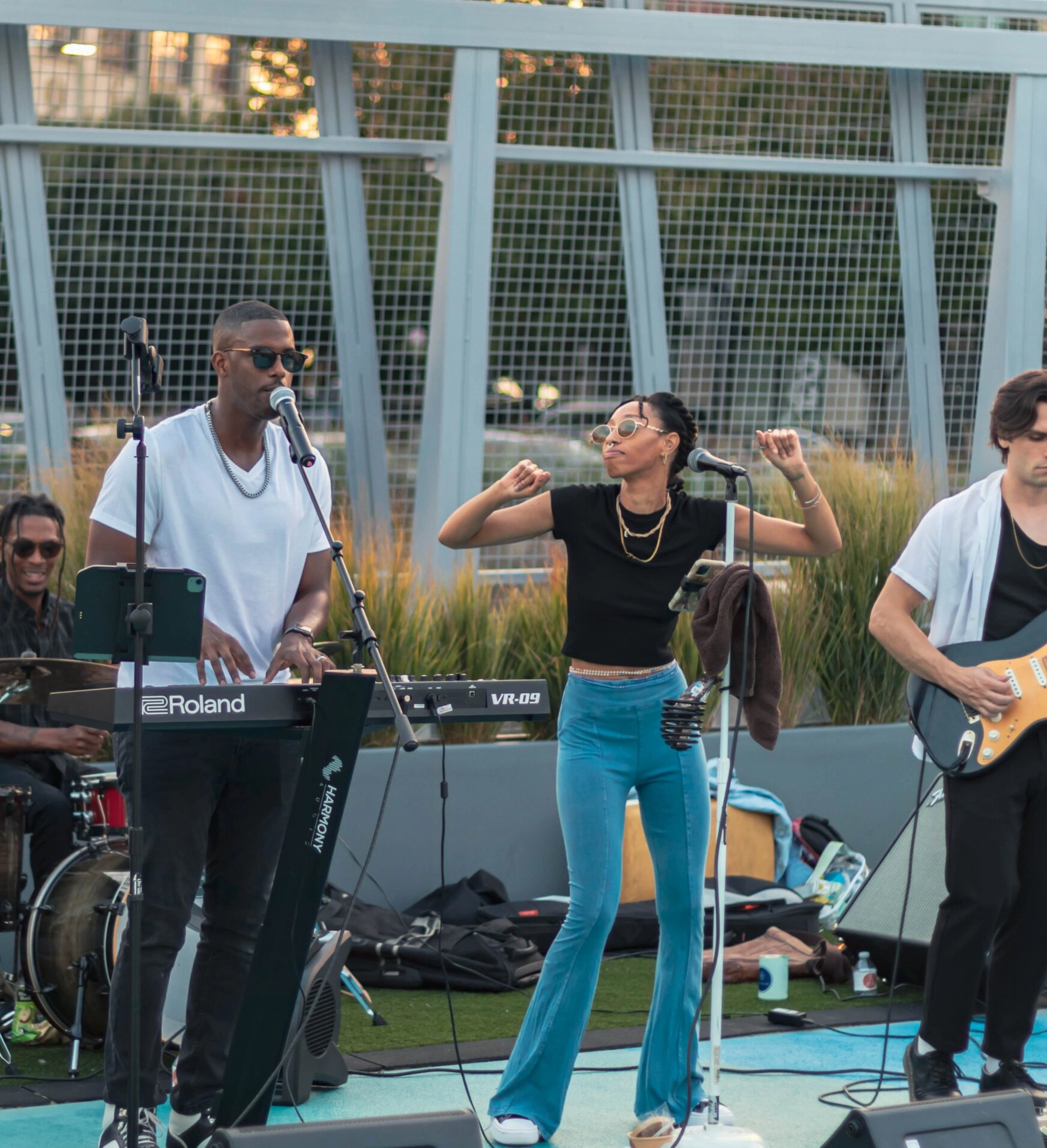 Chops singing at the keys with the band outdoors