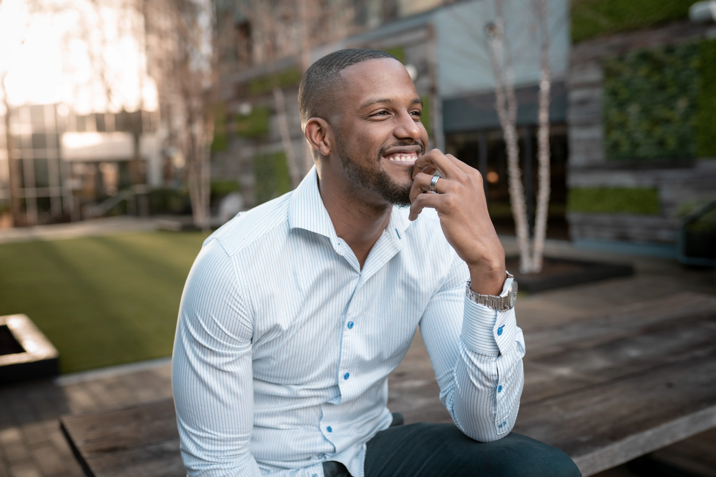 Chops smiling in a white shirt outdoors