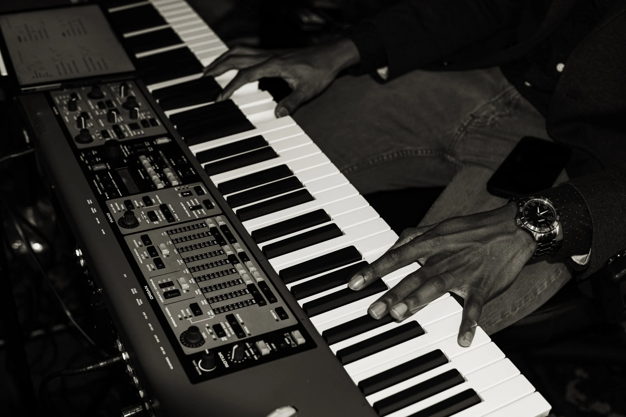 Close-up of hands on a stage piano