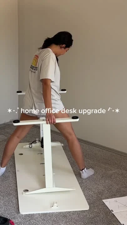 Still from Lola’s electric standing desk video