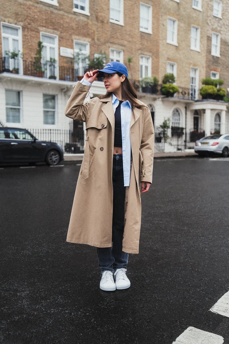 Street-style portrait of a woman in a tan coat