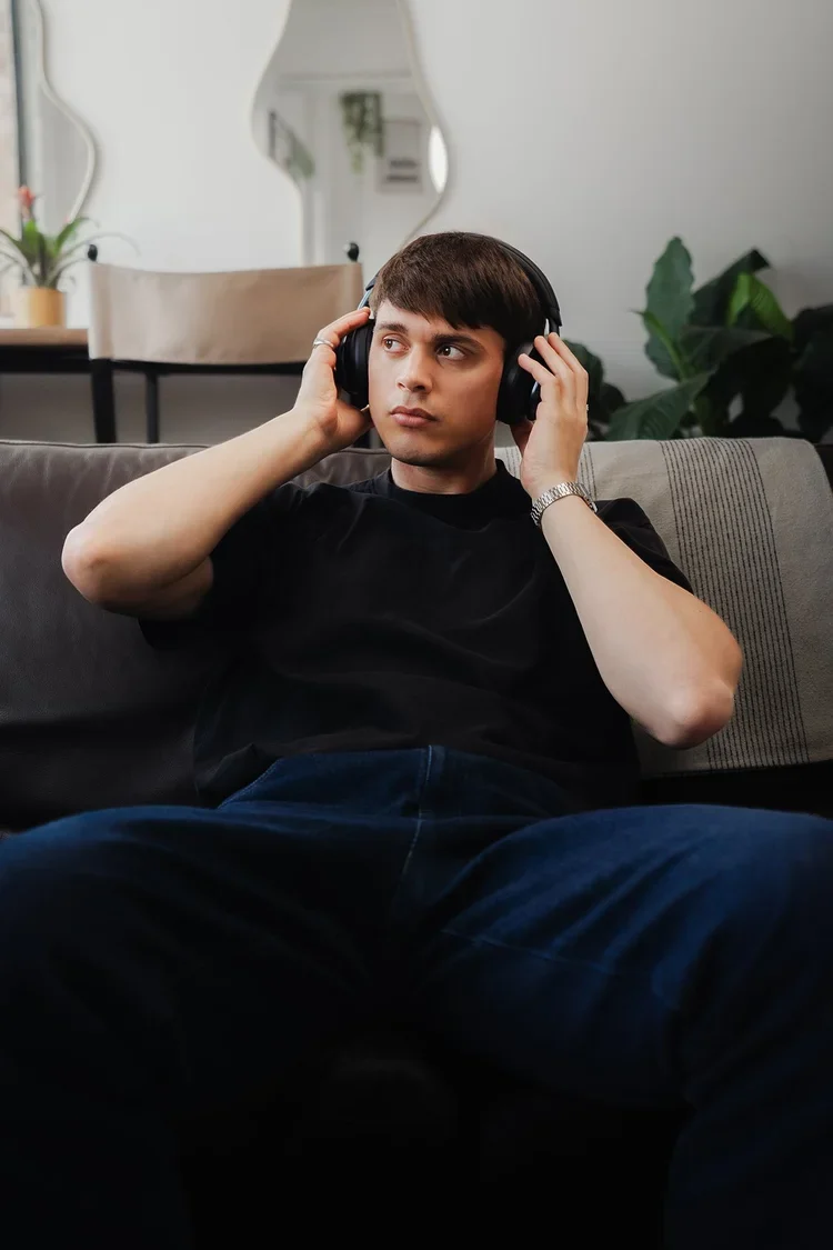 Indoor lifestyle portrait of a man wearing headphones