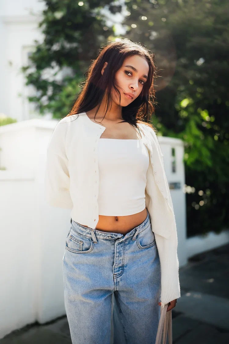 Bright lifestyle portrait of a woman in a white top