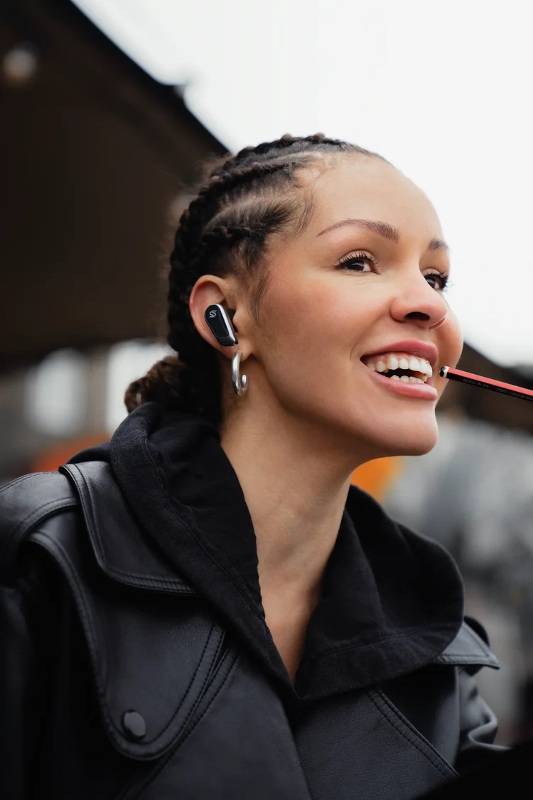 Smiling woman wearing wireless earbuds