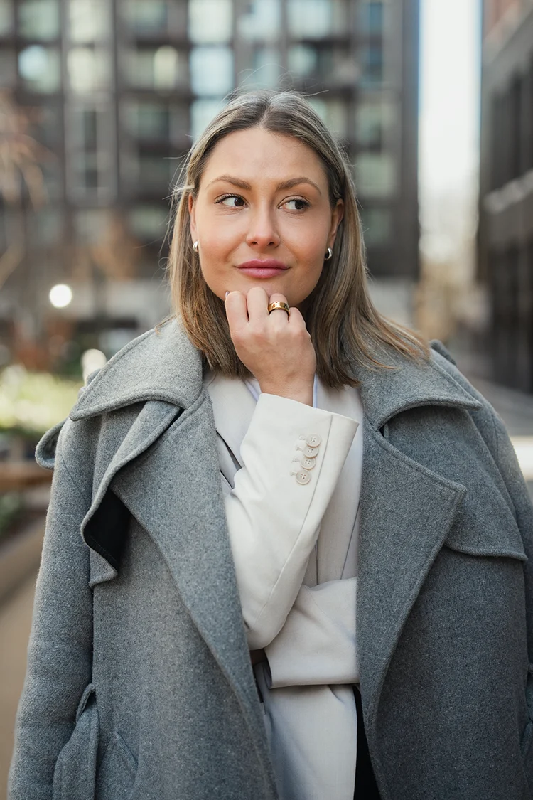 City portrait of a woman in a grey coat