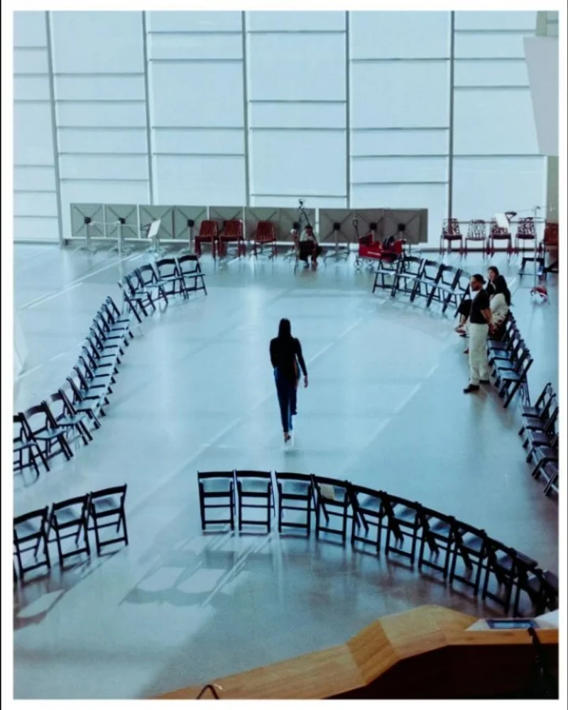 Film photograph of a runway surrounded by chairs