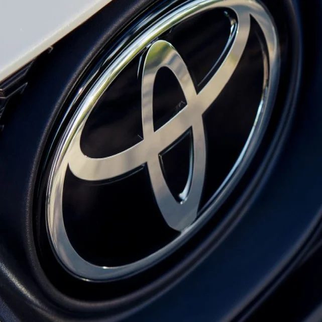 Close-up of the Toyota badge on a white grille