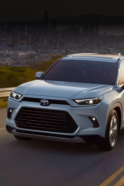 A light blue Toyota Grand Highlander on the road