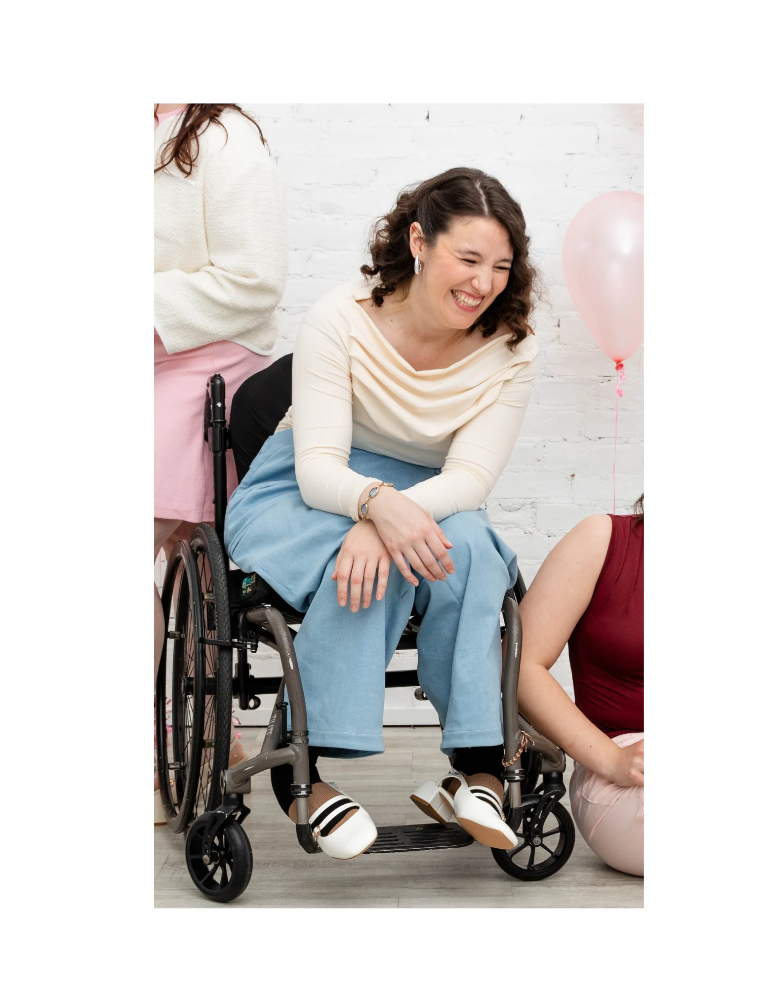 Model seated in a wheelchair wearing the Hey Laney jeans