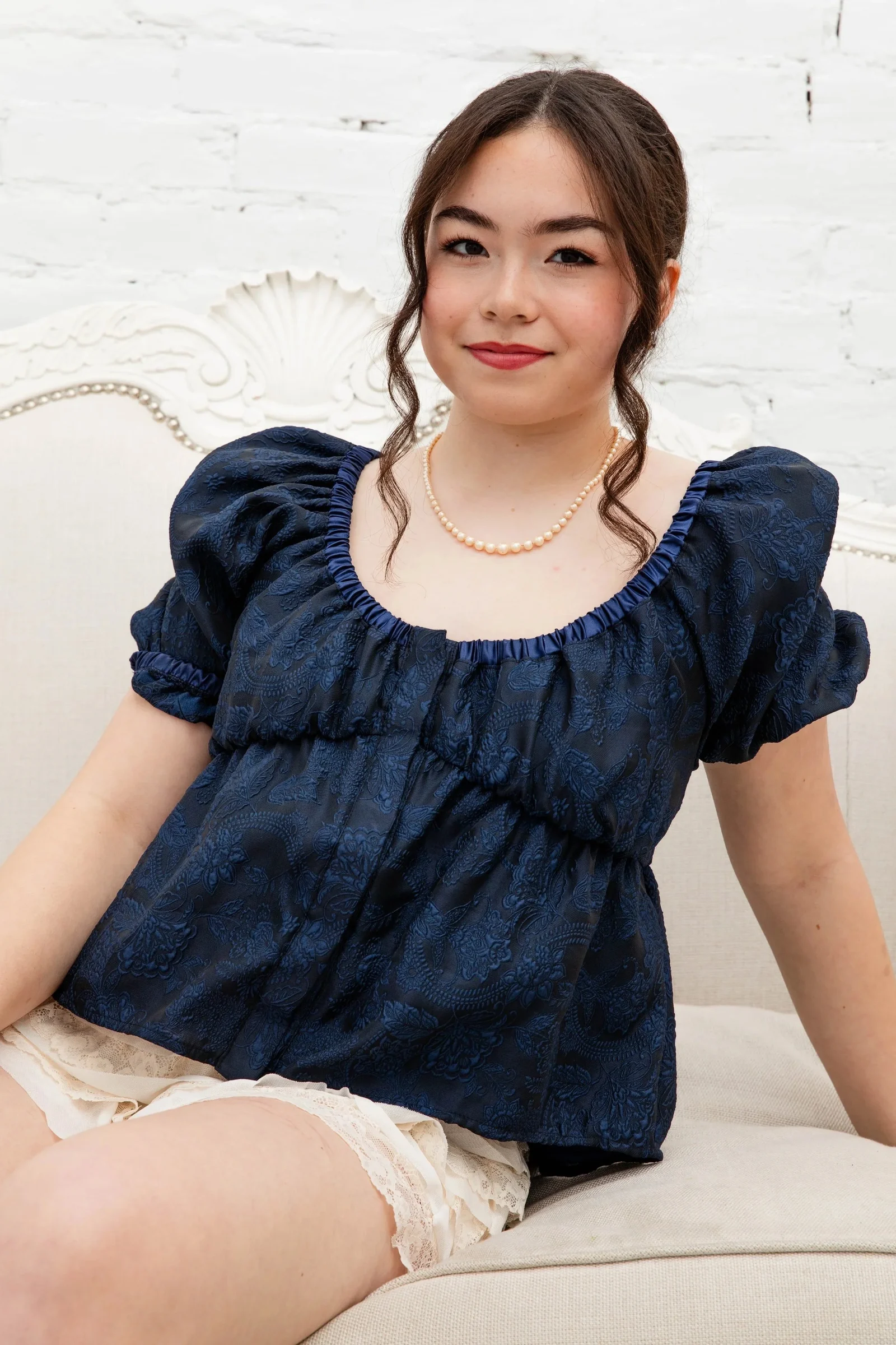 Model wearing the navy Dear Caroline brocade blouse