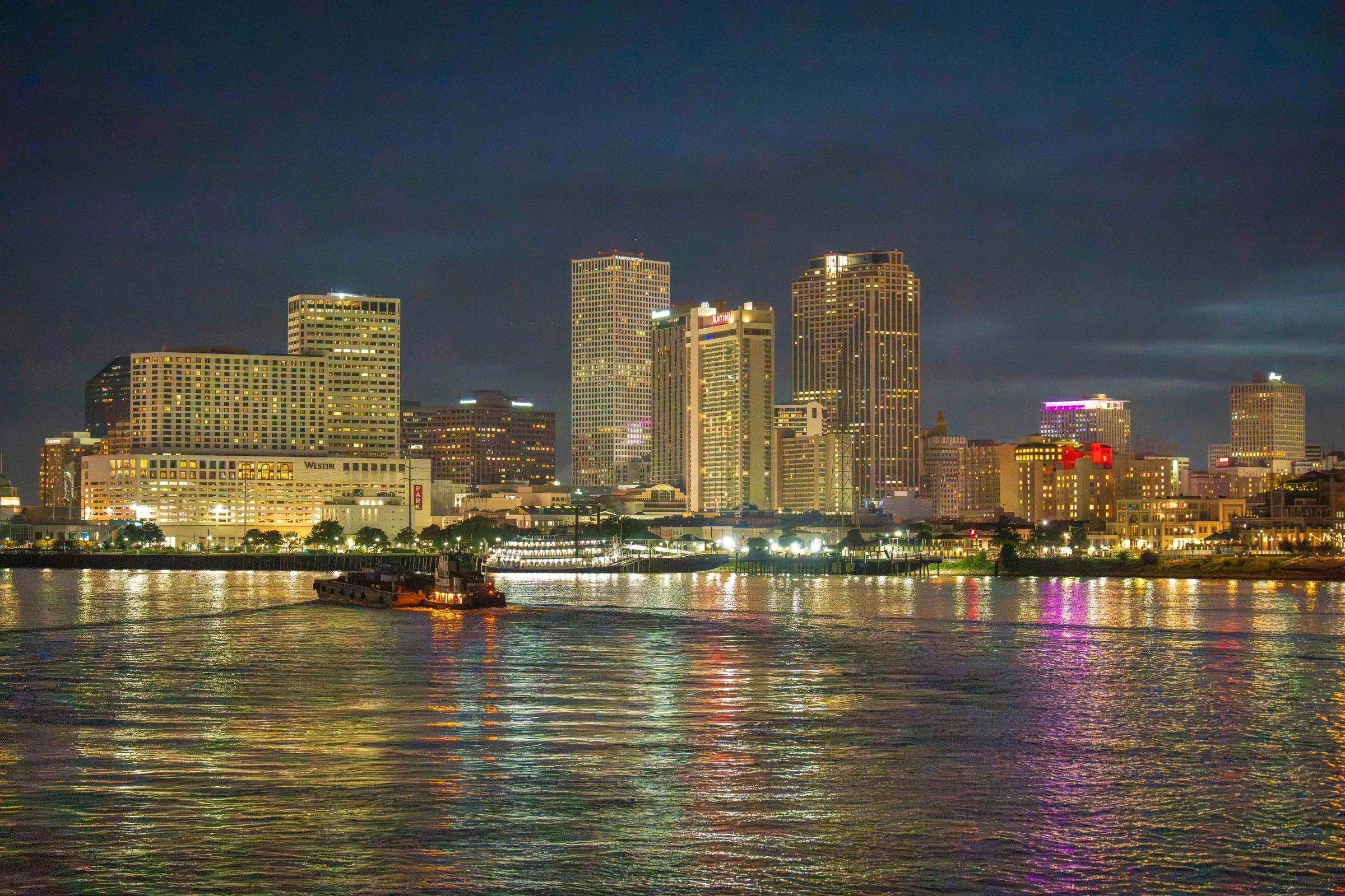 New Orleans skyline at night reflected in the Mississippi River
