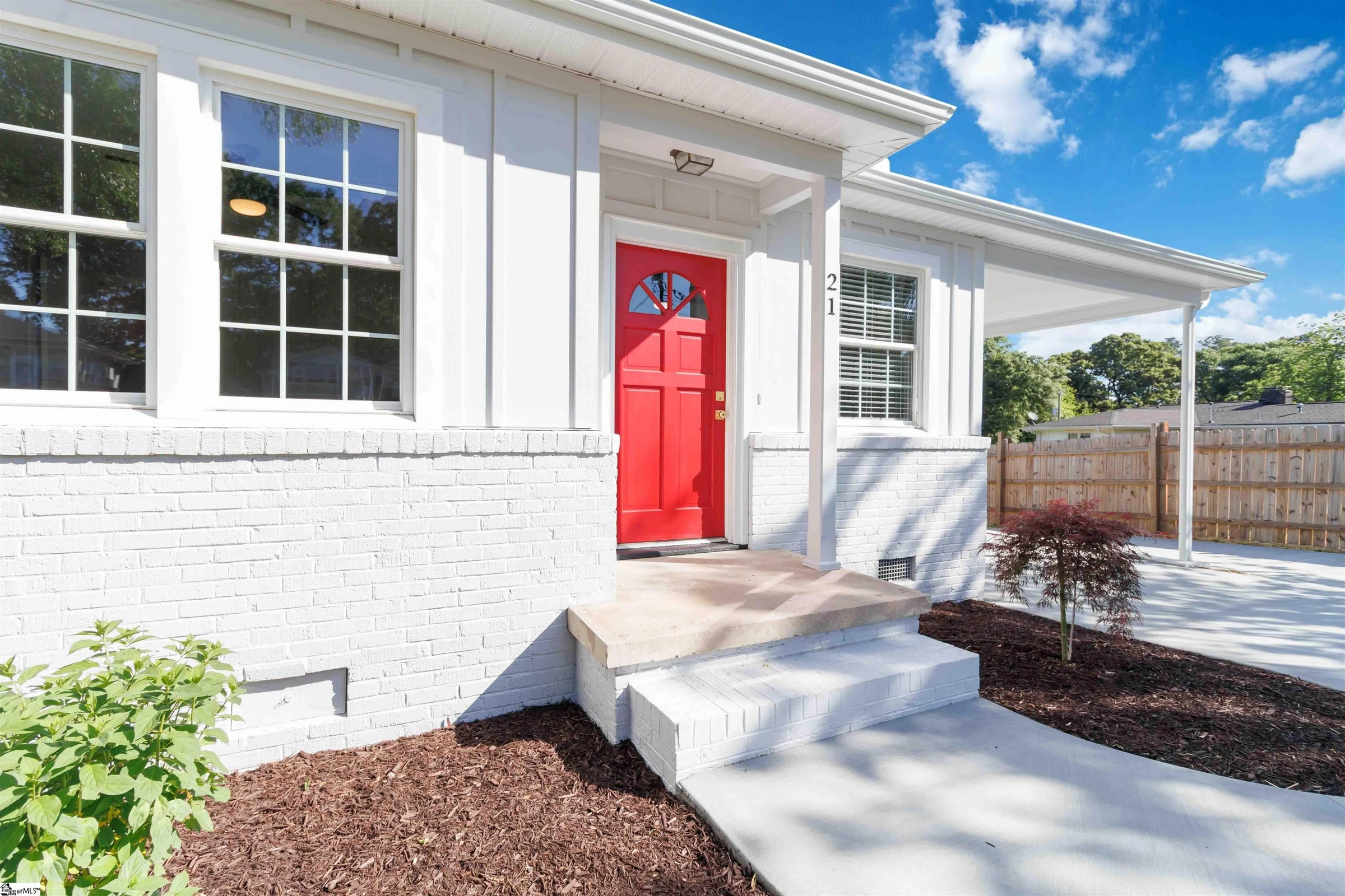 White brick front with a bright red door