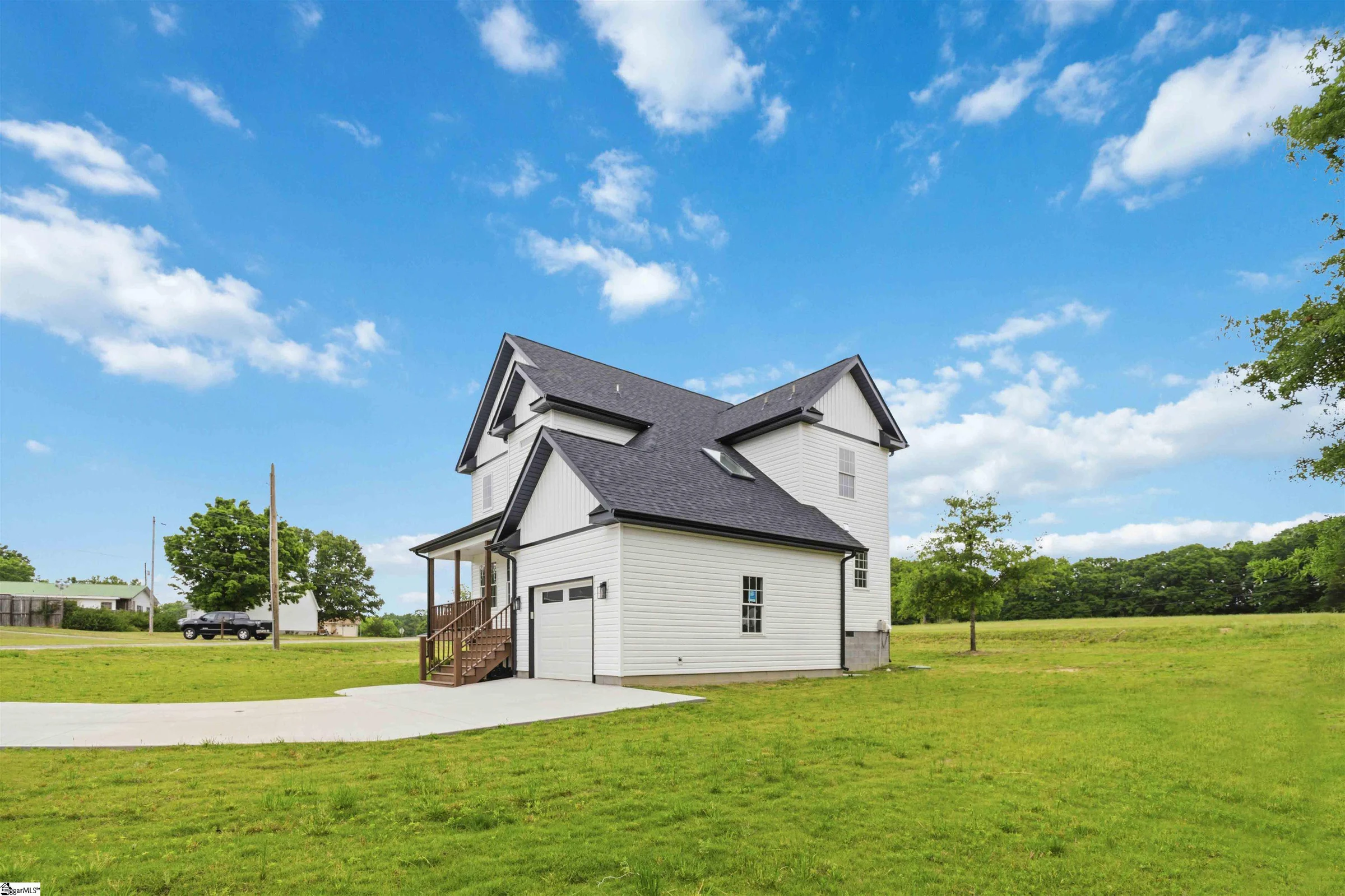 White farmhouse on a wide green lawn