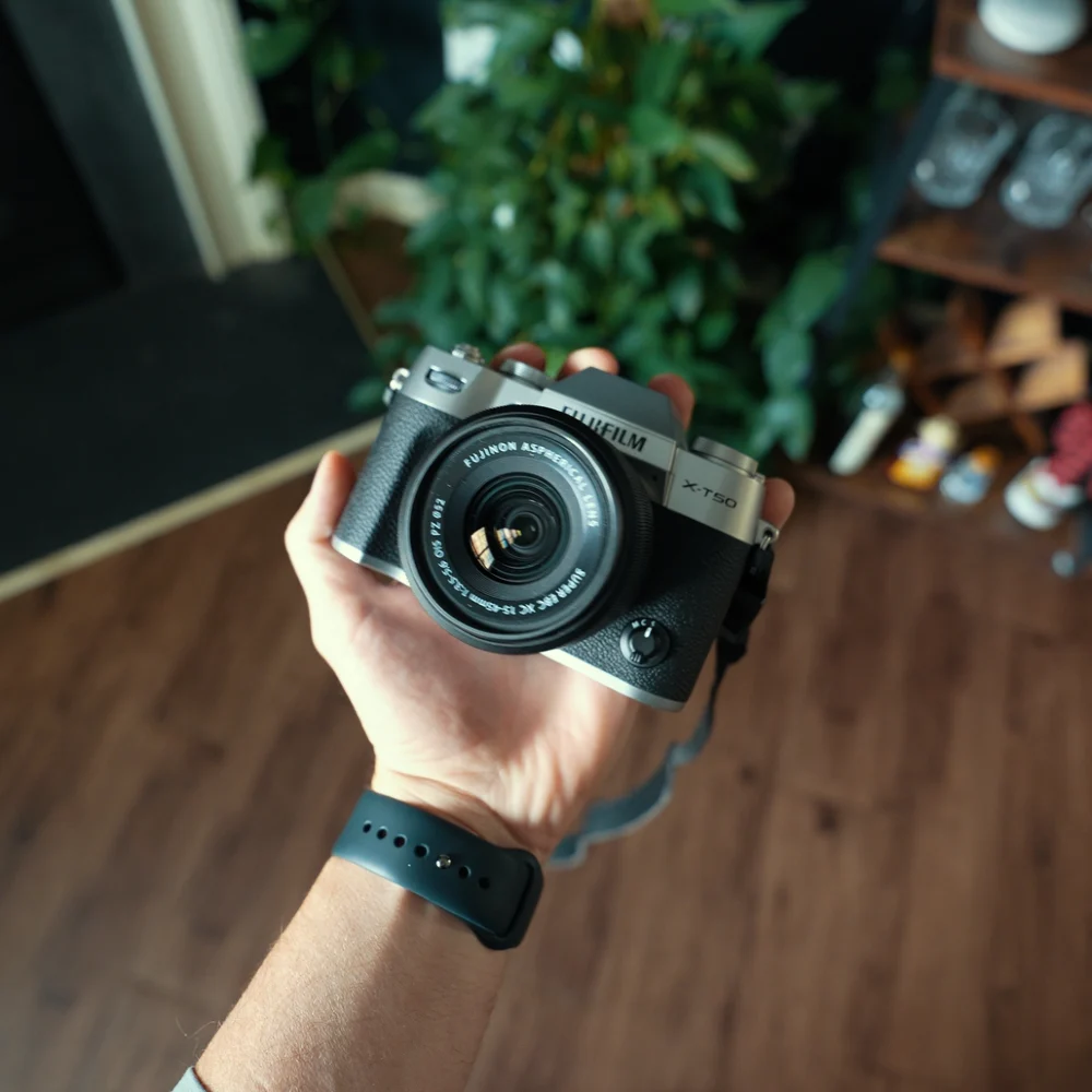 Fujifilm X-T50 camera held in one hand