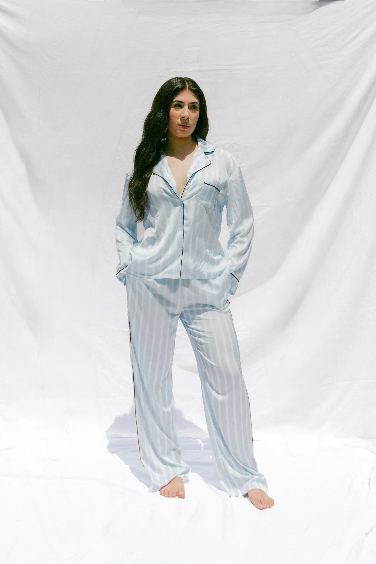Model wearing the sky blue TOREY satin pajama set