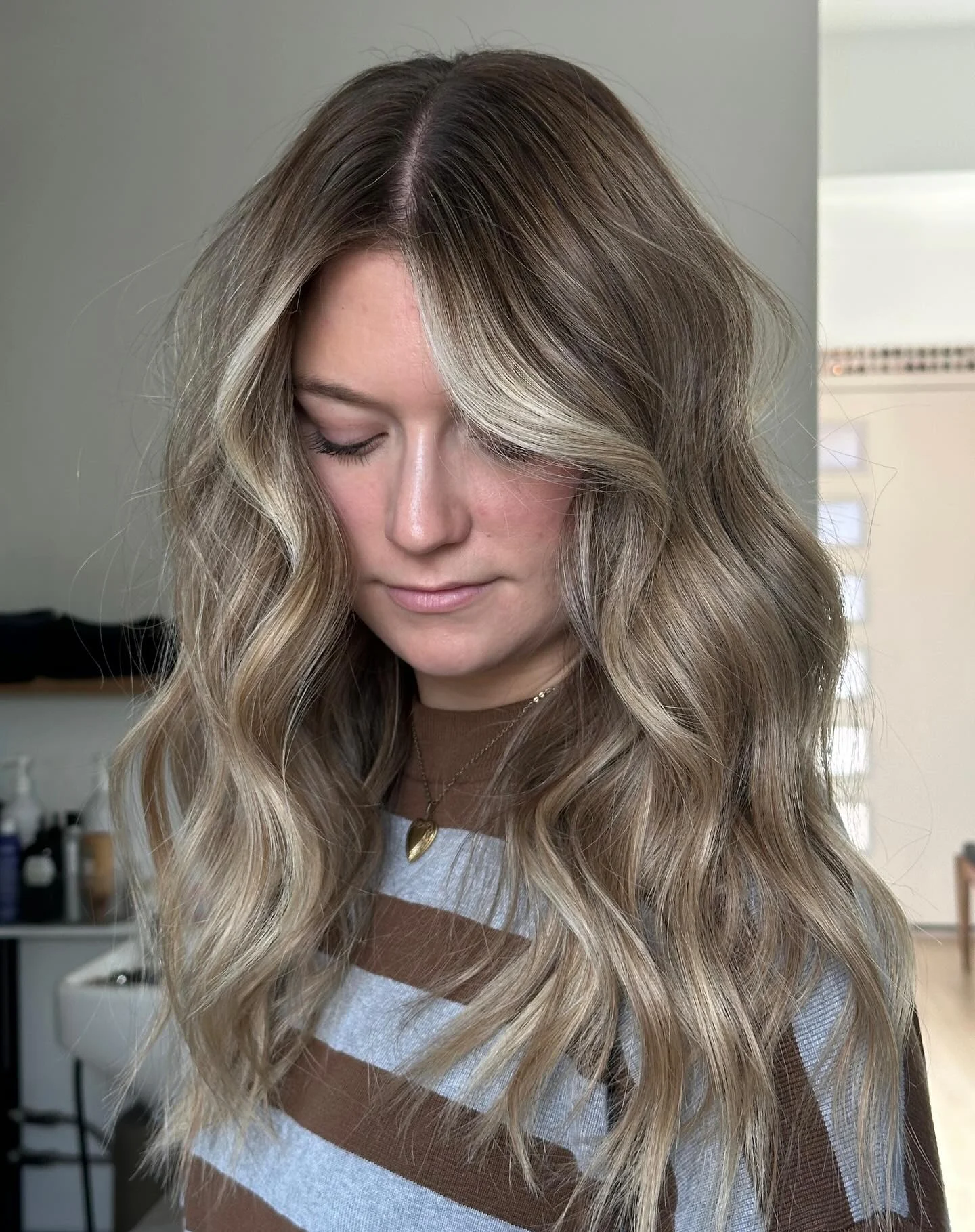 Bronde waves over a striped sweater