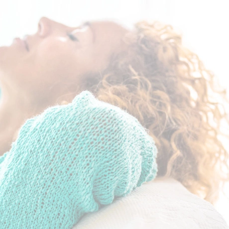 Woman relaxing with her eyes closed in a mint sweater