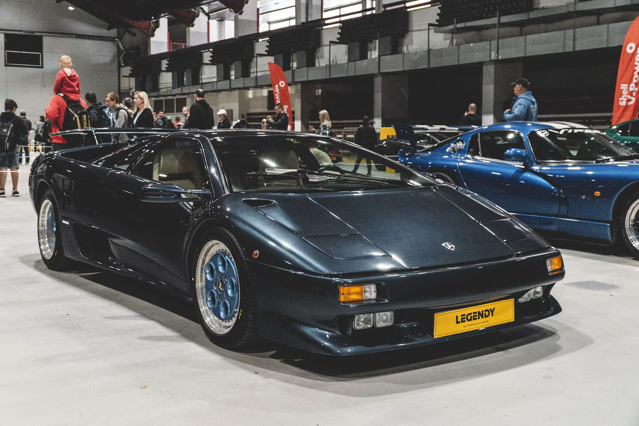 Yellow Lamborghini Diablo VT against a concrete wall