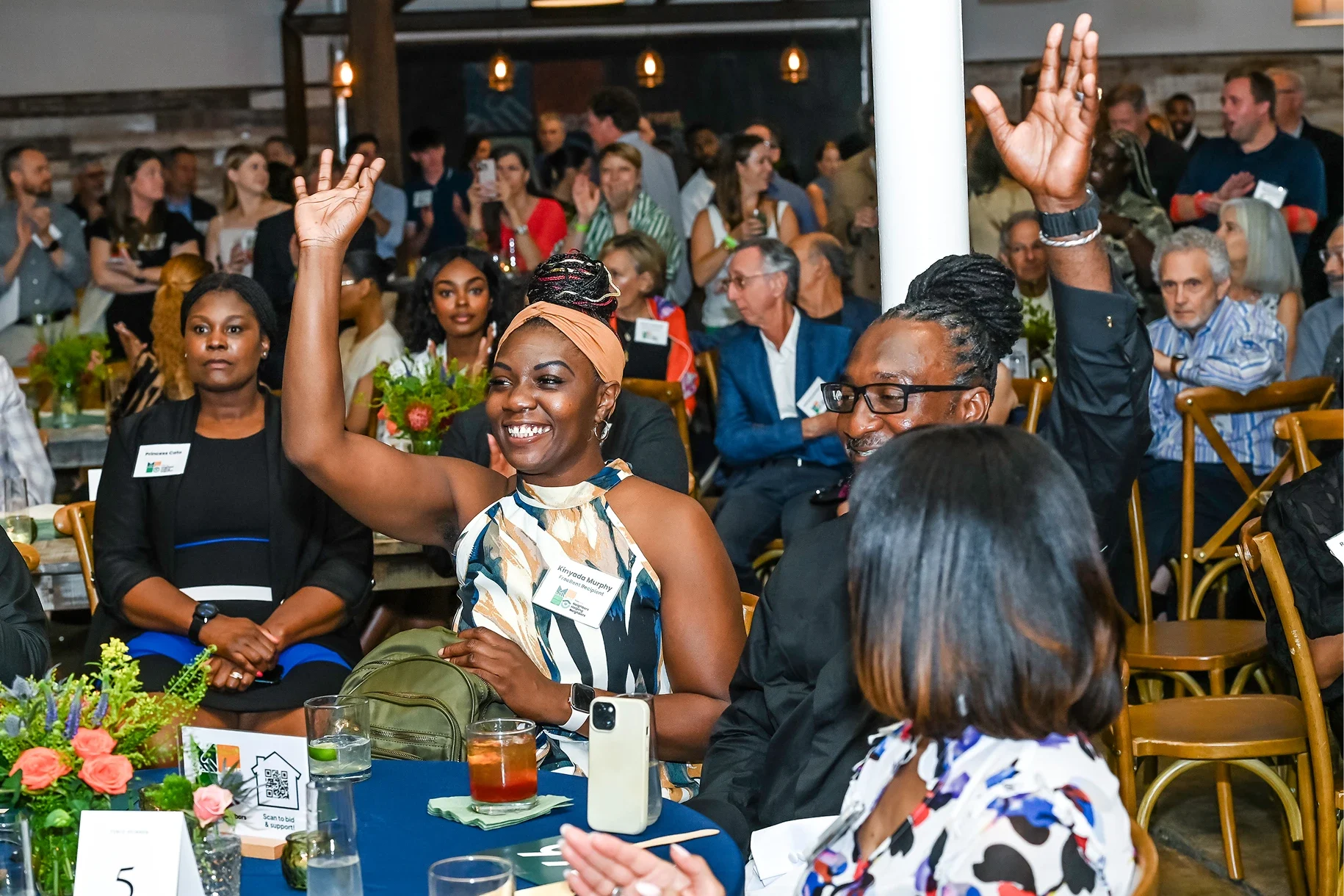 Guests cheering at a FreeRent community fundraiser