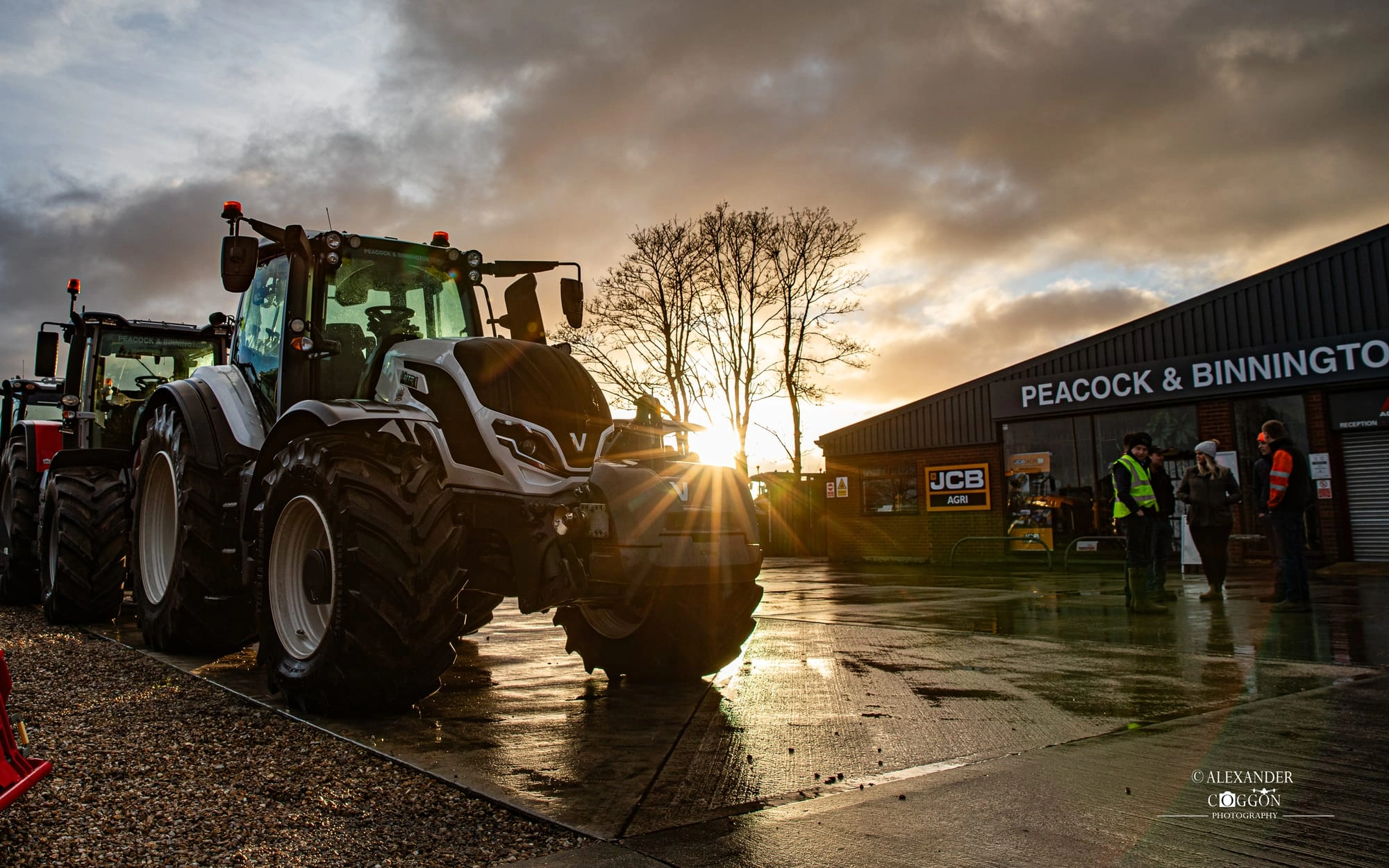 Tractor at a dealership yard at sunrise