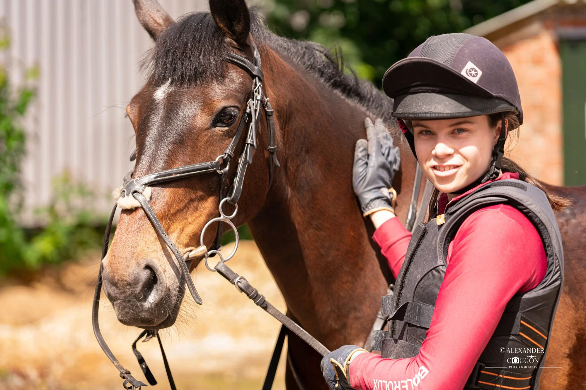 Young rider smiling beside her horse