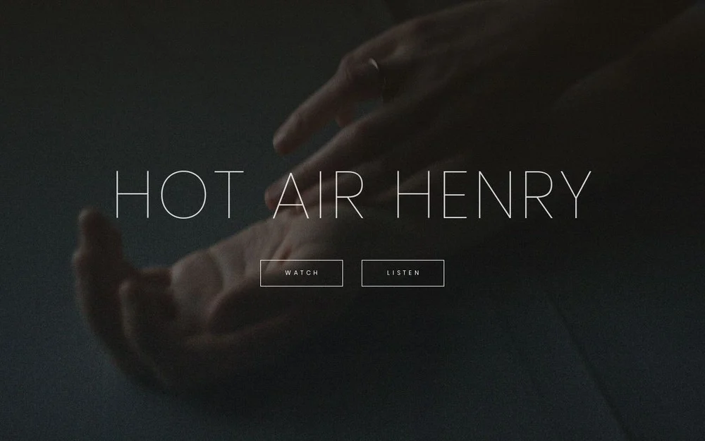 Hot Air Henry artwork with hands in soft focus
