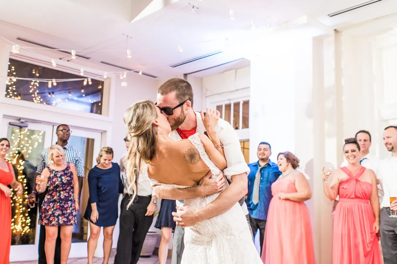 Newlyweds kissing on a bright dance floor