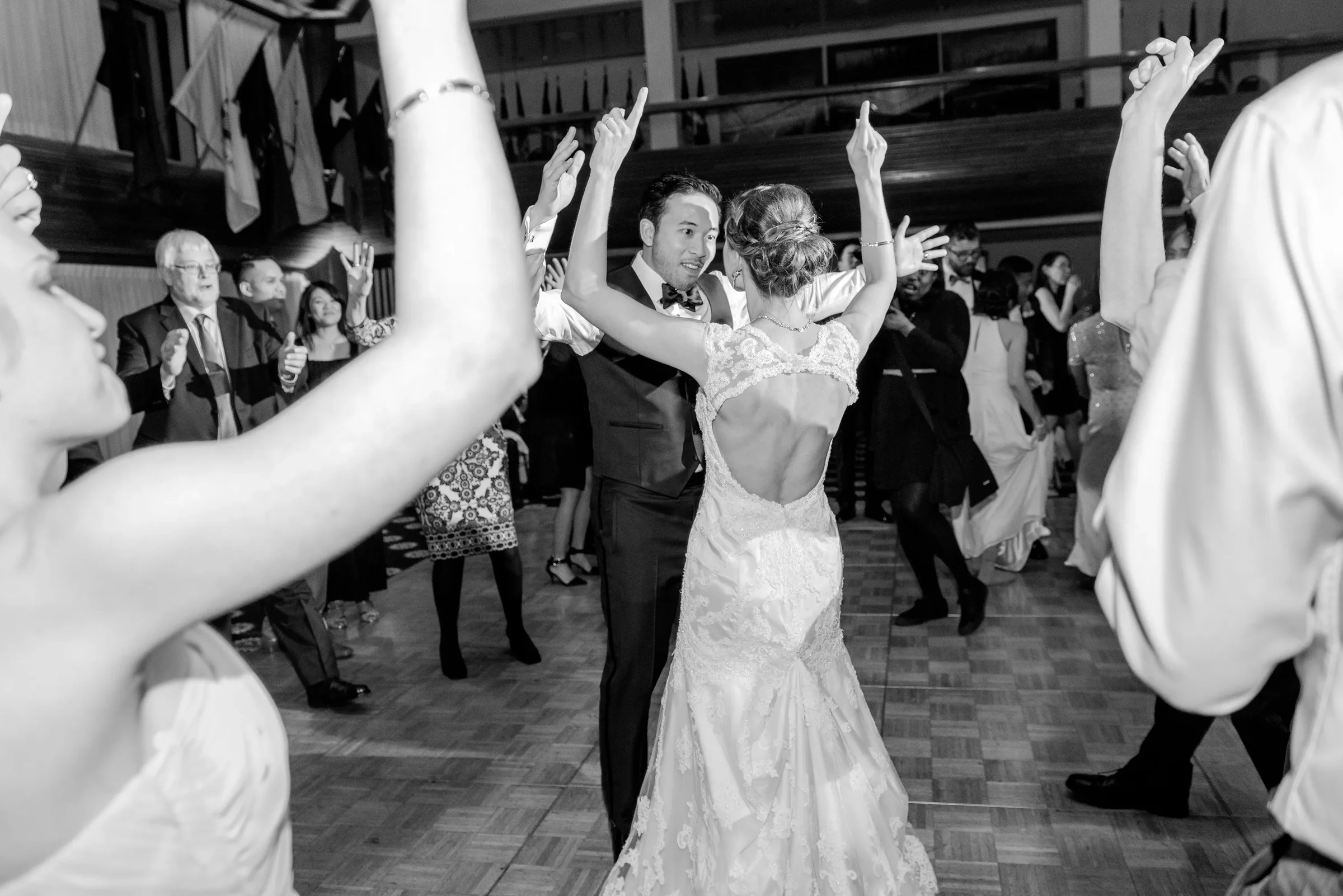 Newlyweds dancing as guests cheer around them