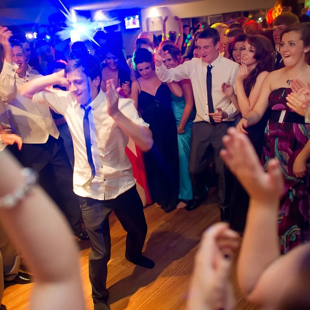 A reception dance floor lit like a nightclub
