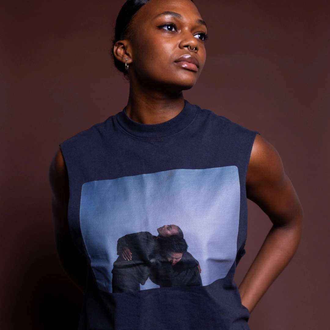 A dancer wearing the navy Portrait Tank printed with a photo of two embracing dancers